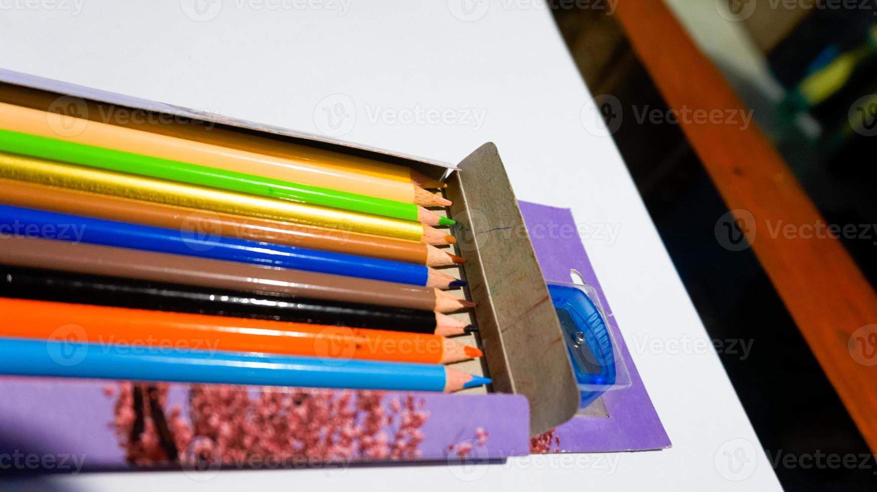 Set of collection of wooden coloring pencils in the box isolated on White Background. photo