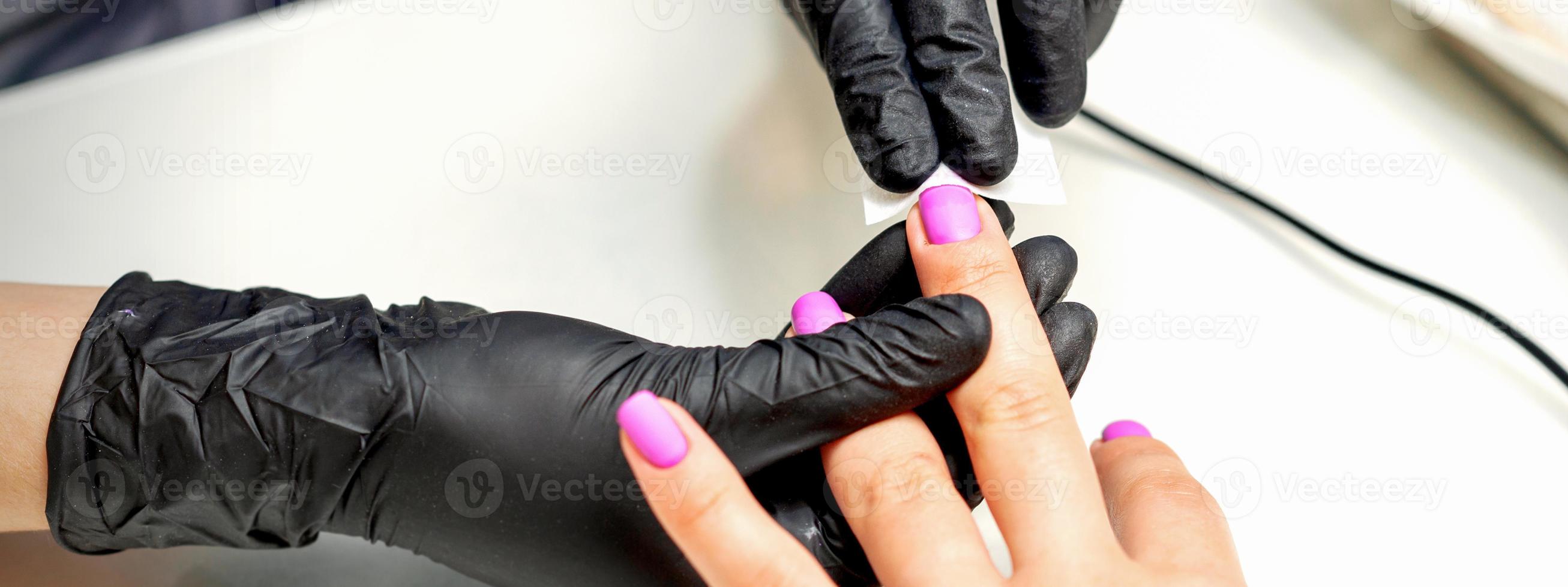 Manicurist applies a matte coating photo