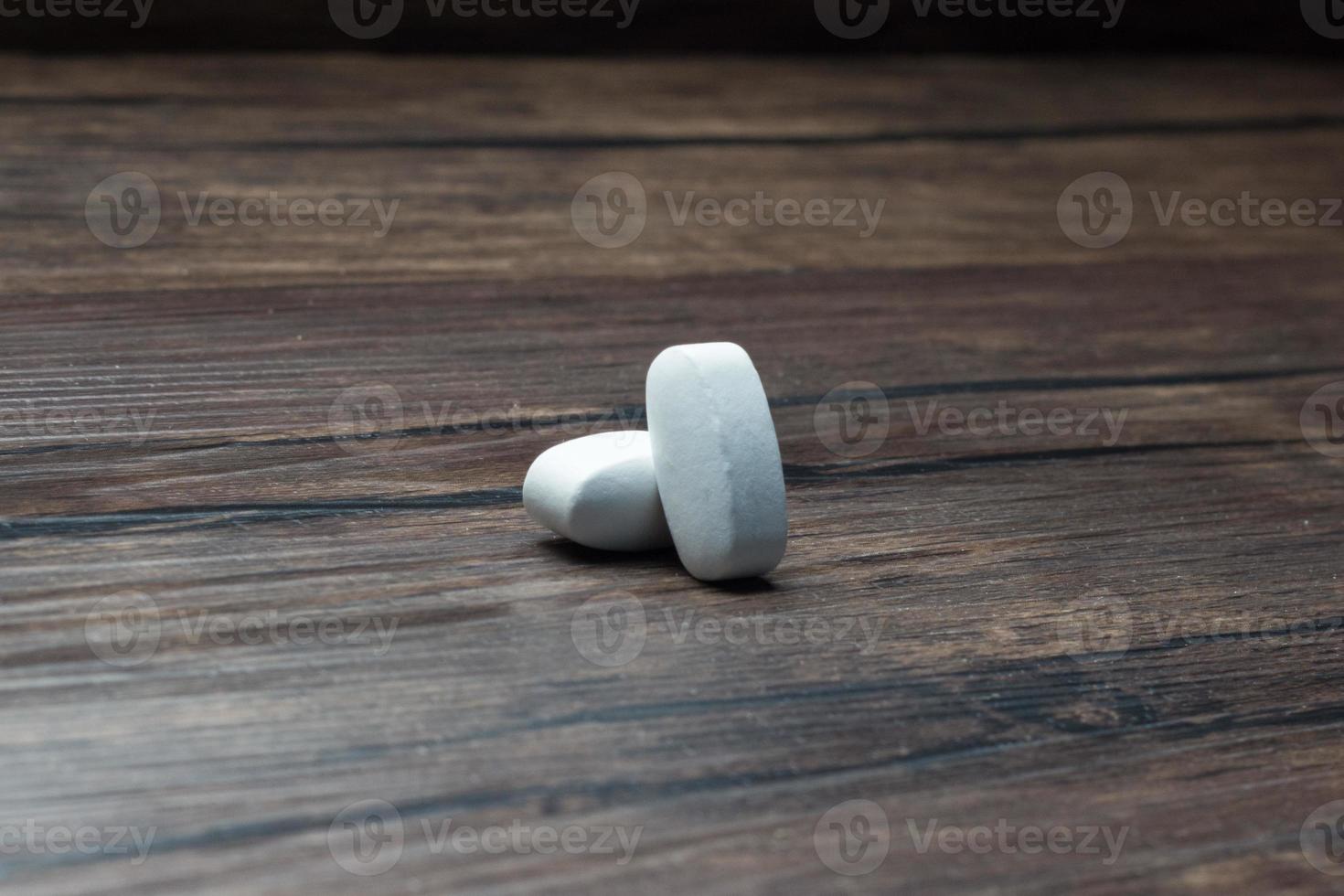 medicine pill tablet, wooden background photo