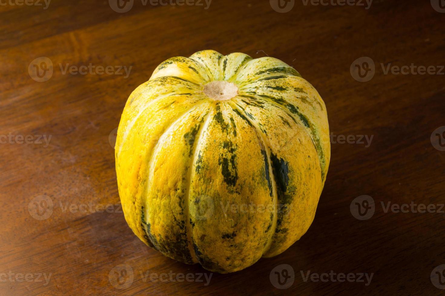 Blewah, Cantaloupe or Cucumis melo, a type of melon found in Indonesia, with a wooden background, cantaloupe is often used to make drinks during the fasting month of Ramadan photo