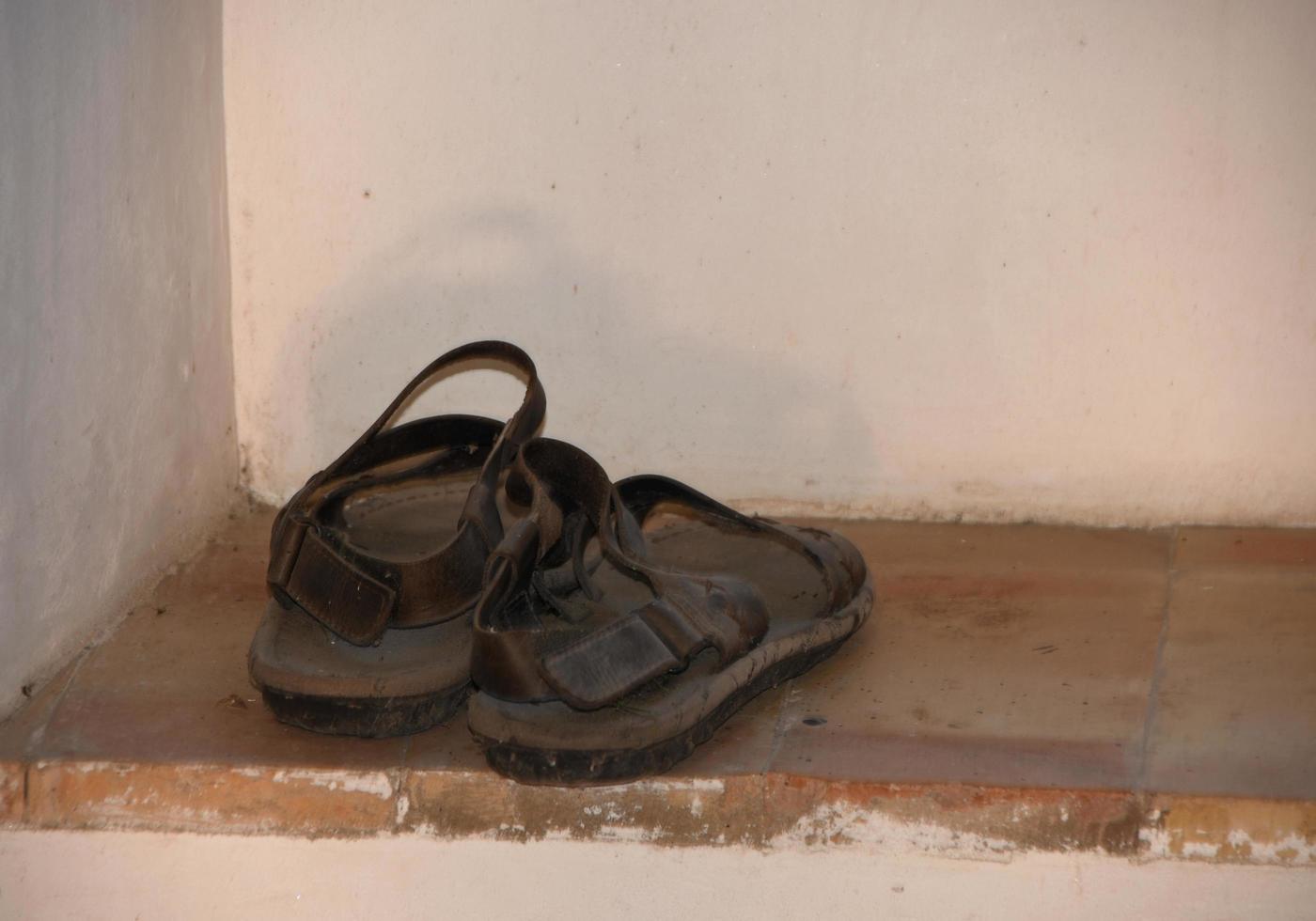 The old monk sandals in a window photo