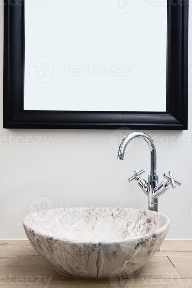 Bathroom interior with marble sink and faucet photo