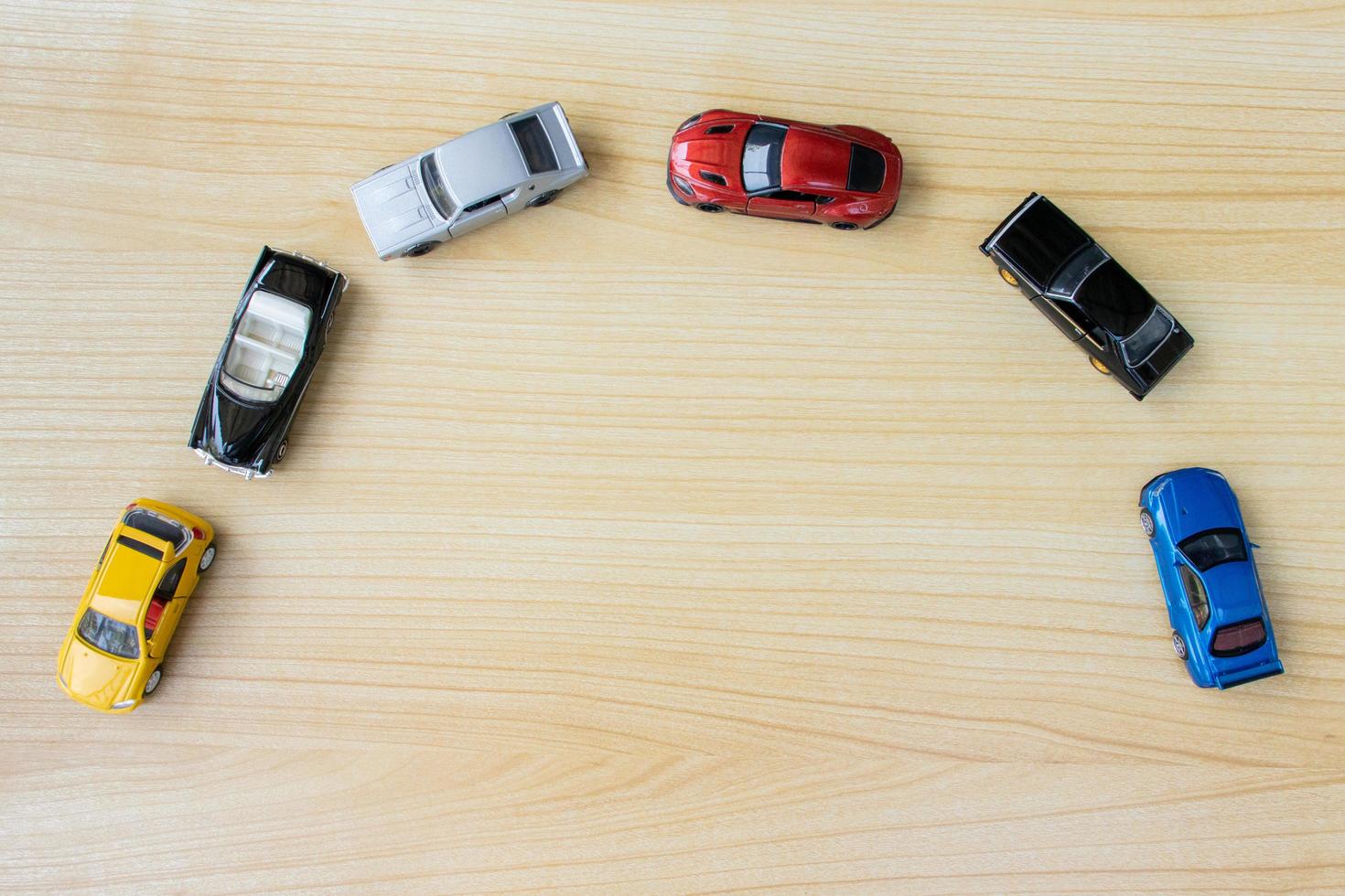 Group of toy cars isolated on wooden background, after some edits. photo