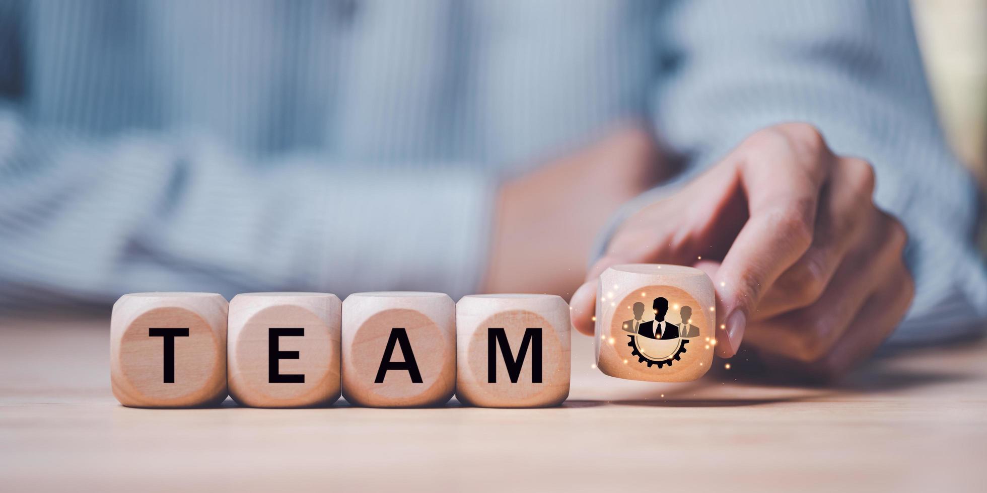 Businessman holding a wooden block ,team business success concept ,cooperation and support colleagues,brainstorming,corporate teamwork ,Successful business team ,Building a team to work together photo
