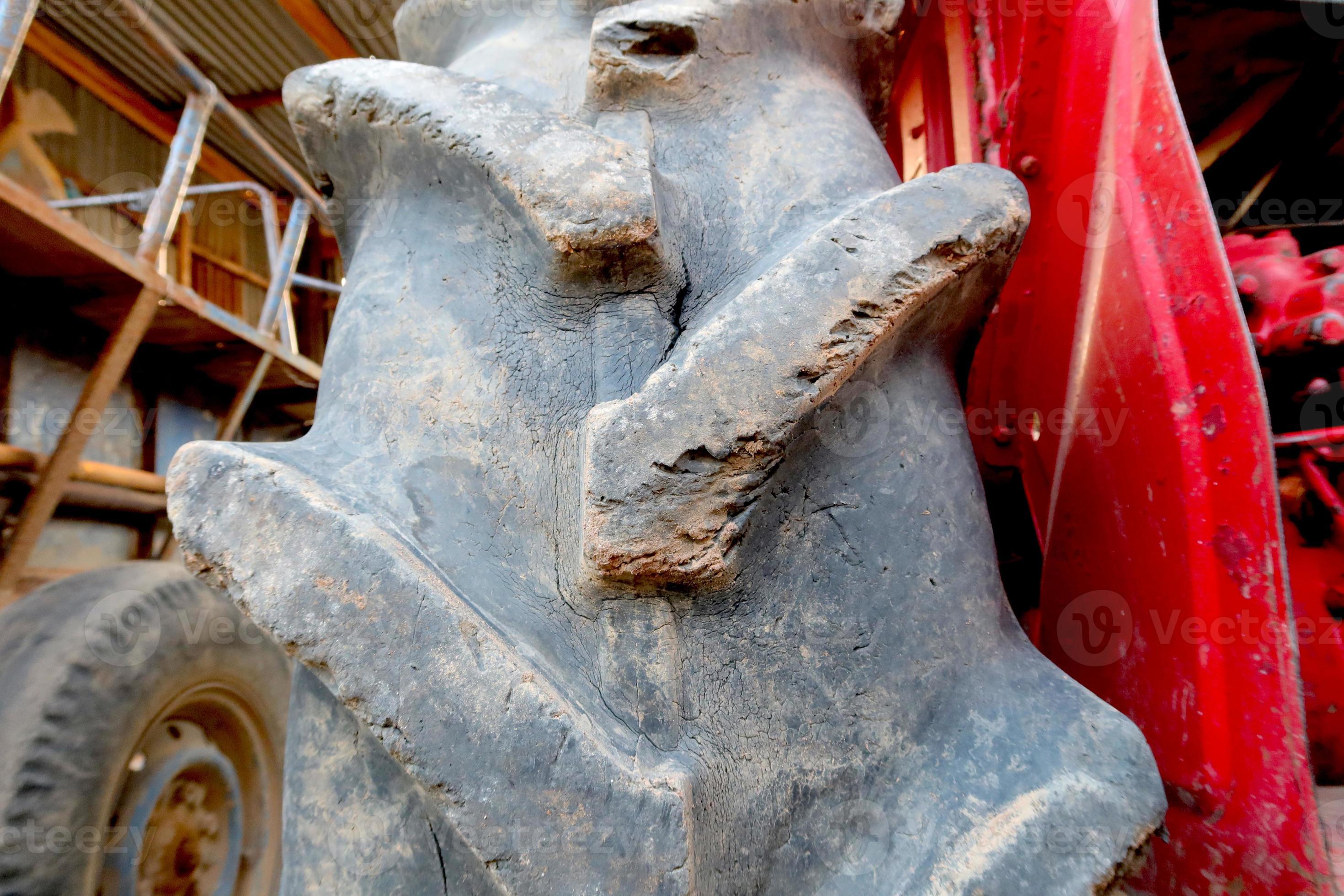 Red tractor with old wheel tire background 21907733 Stock Photo at Vecteezy