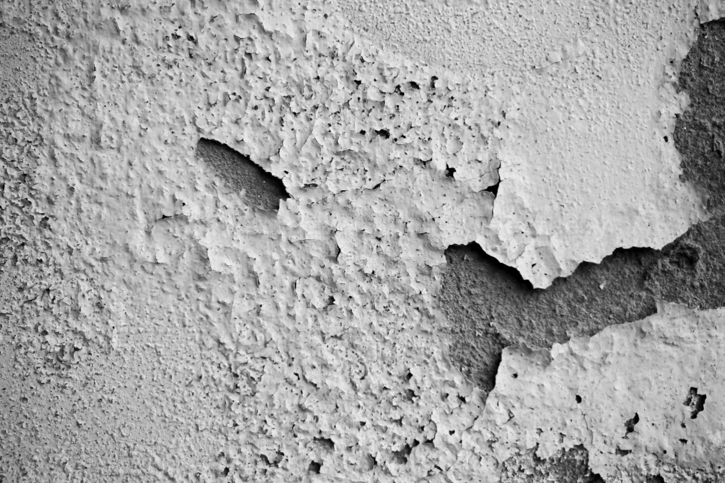 White damp wall showing paint cracking open and breaking or peeling off