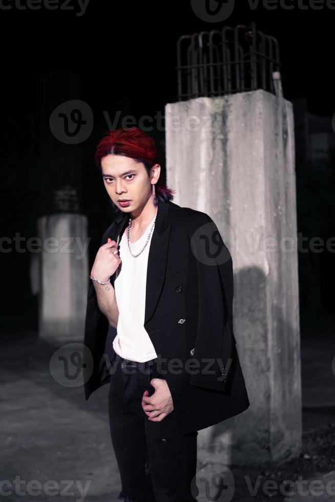 a red haired asian man wearing a white t shirt and black suit photo