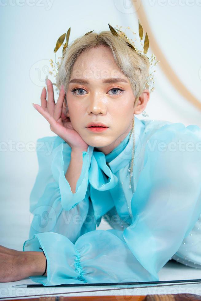 a woman with flawless makeup wearing a golden crown on her blonde hair photo