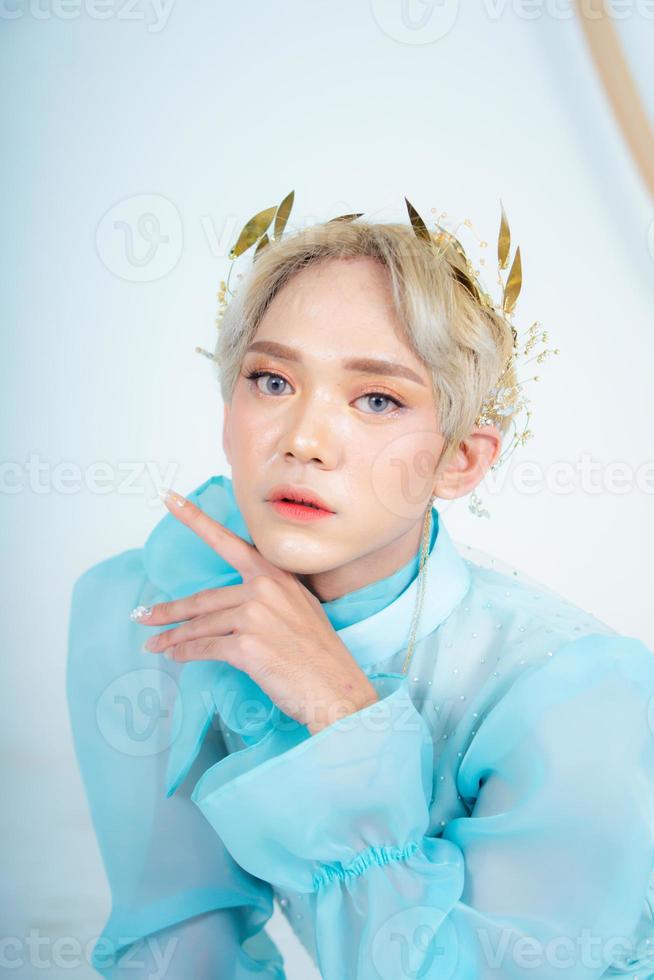 a royal princess posing with a golden crown and blonde hair very cutely photo