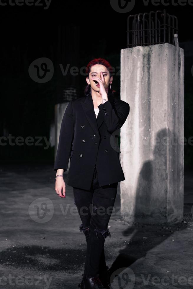 a red haired asian man wearing a white t shirt and black suit photo