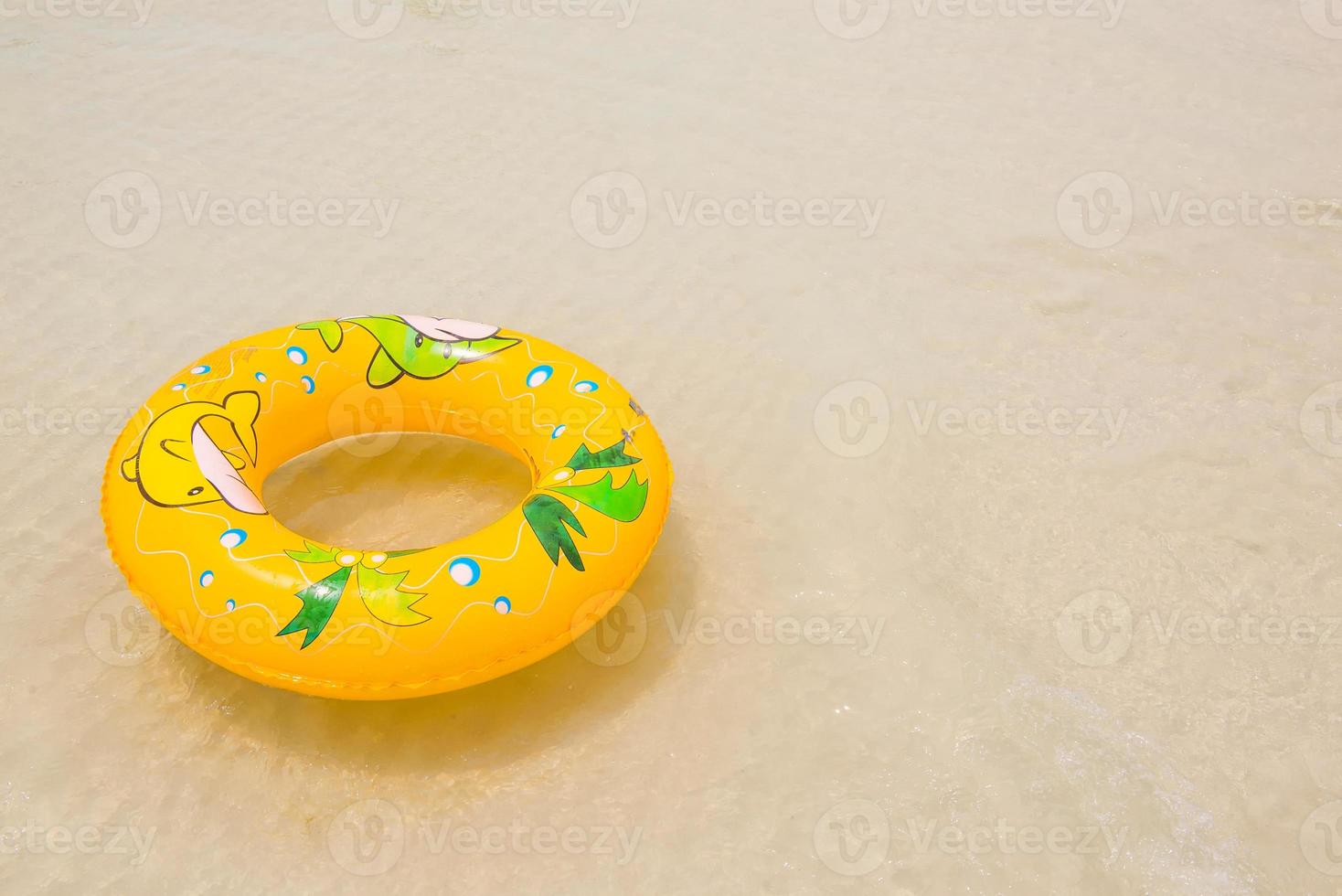 orange pool float, pool ring on the beach photo