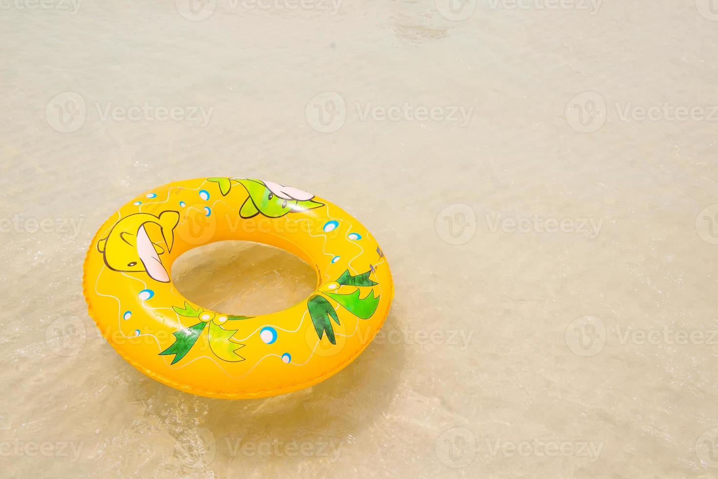 orange pool float, pool ring on the beach photo