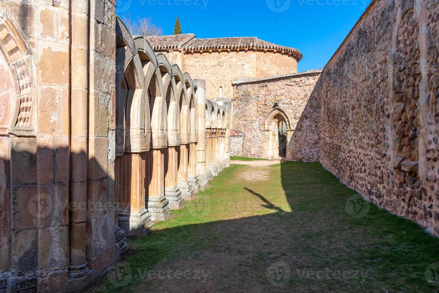 Romanesque monastery courtyard with stone arches photo