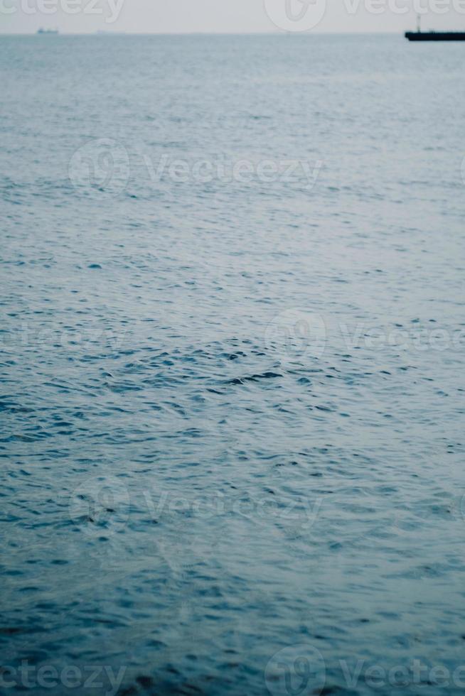 Ocean waves with a boat in the background photo