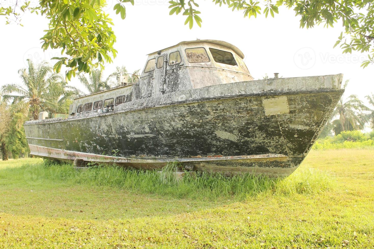 An old boat on the grass in a park. photo