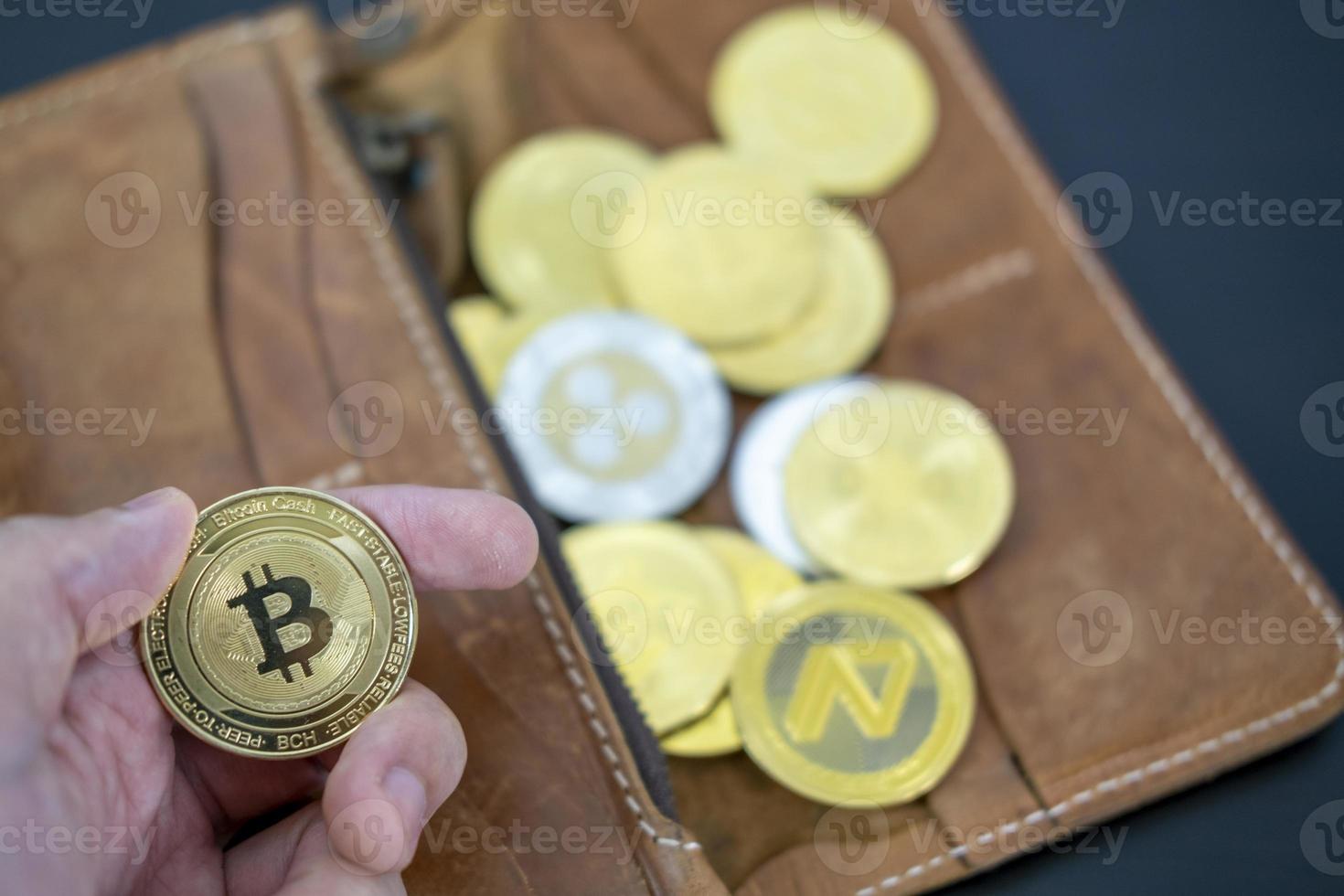 Hand holding cryptocurrency coins on wallet. Bitcoin on wood desk table background. Virtual cryptocurrency concept. digital for defi decentralized financial banking p2p exchange investment technology photo