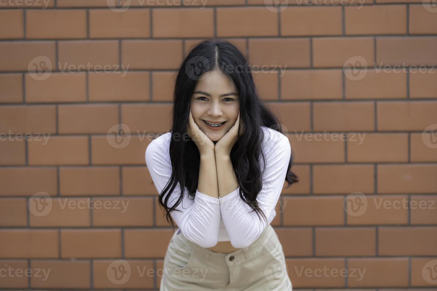 Portrait of hipster girl on brick wall background,Beautiful asian woman pose for take a photo,Kawaii style photo