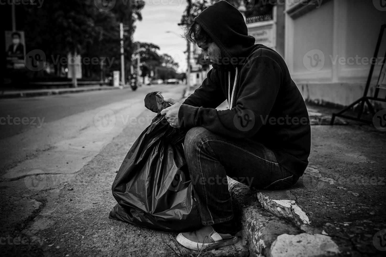 Asian man is homeless at the side road,A stranger has to live on the road alone because he has no family. photo