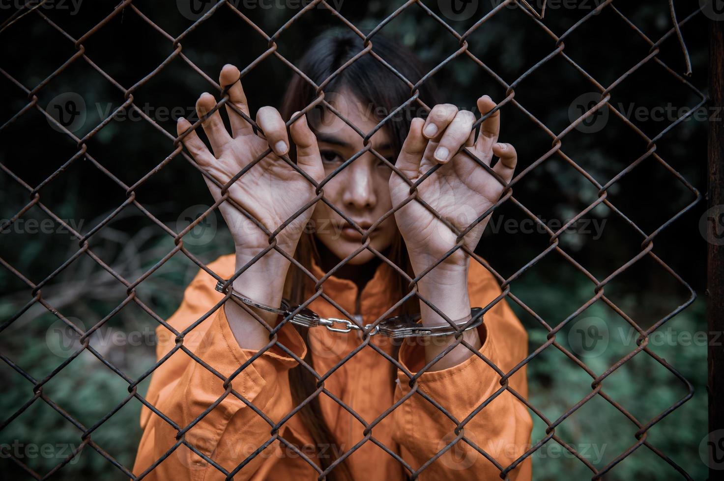 Prisoner in orange robe concept,Portrait of asian woman in Prison uniforms on white background, photo