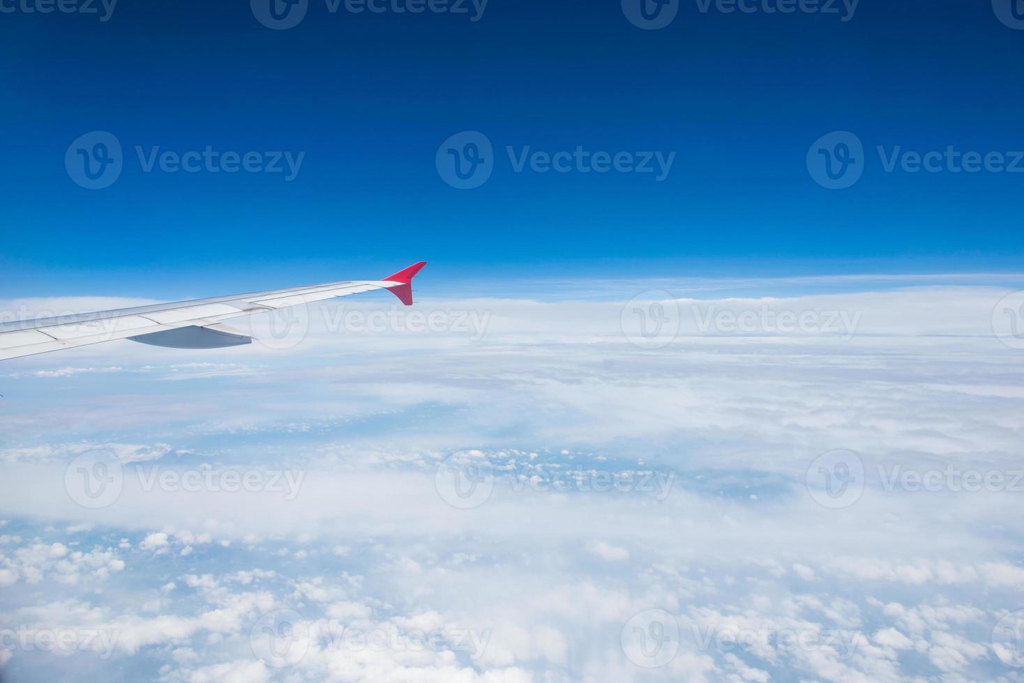 Wing of an airplane flying in the sky photo