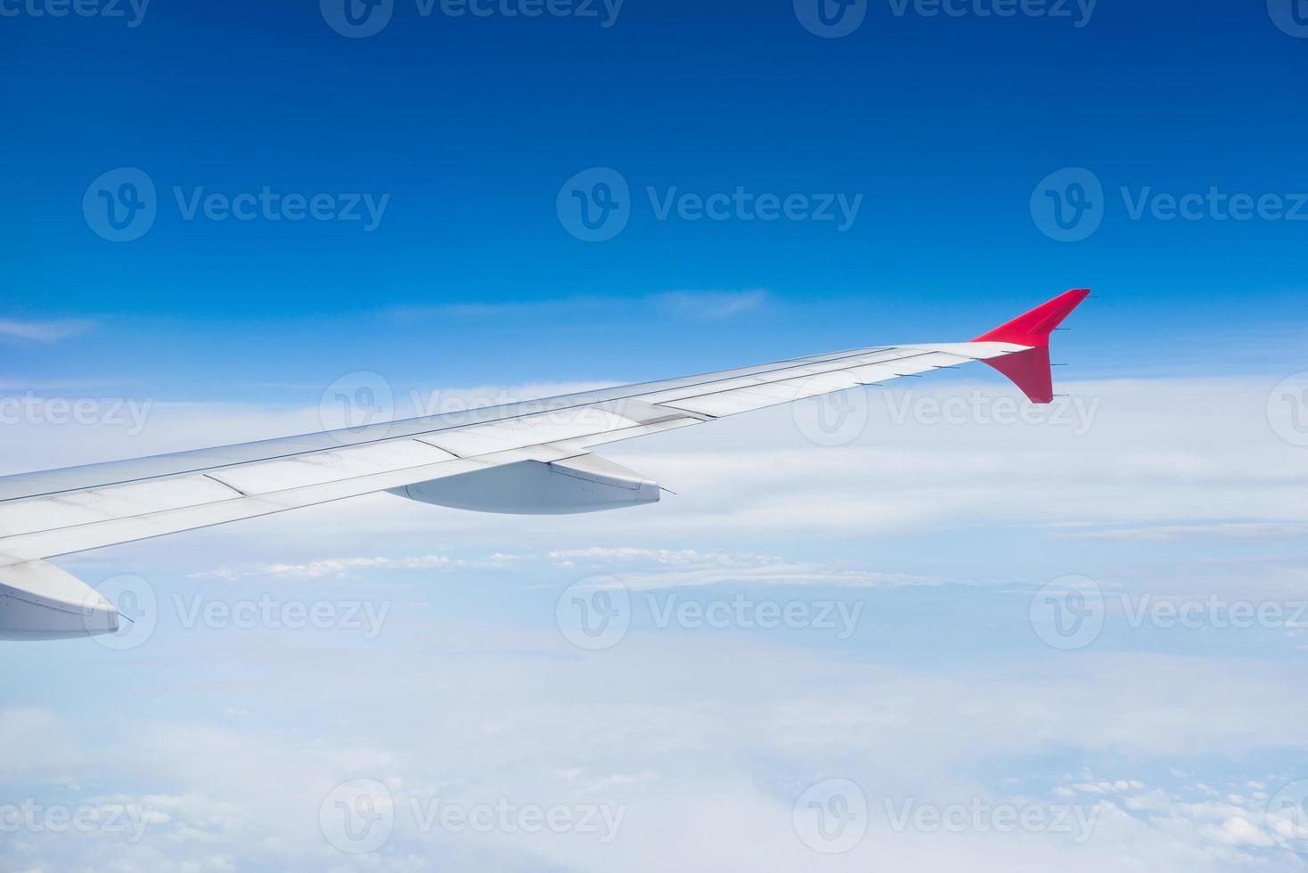 Wing of an airplane flying in the sky photo