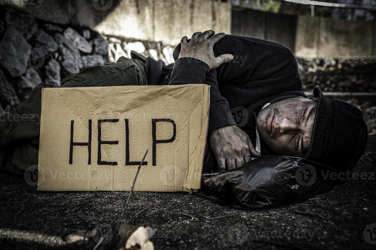 Asian man is homeless at the side road,A stranger has to live on the road alone because he has no family. photo