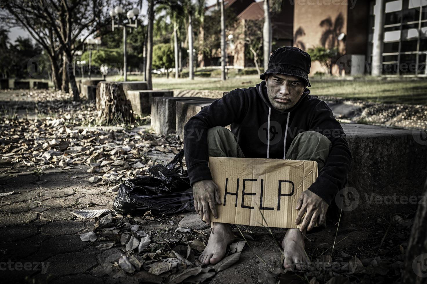 Asian man is homeless at the side road,A stranger has to live on the road alone because he has no family. photo