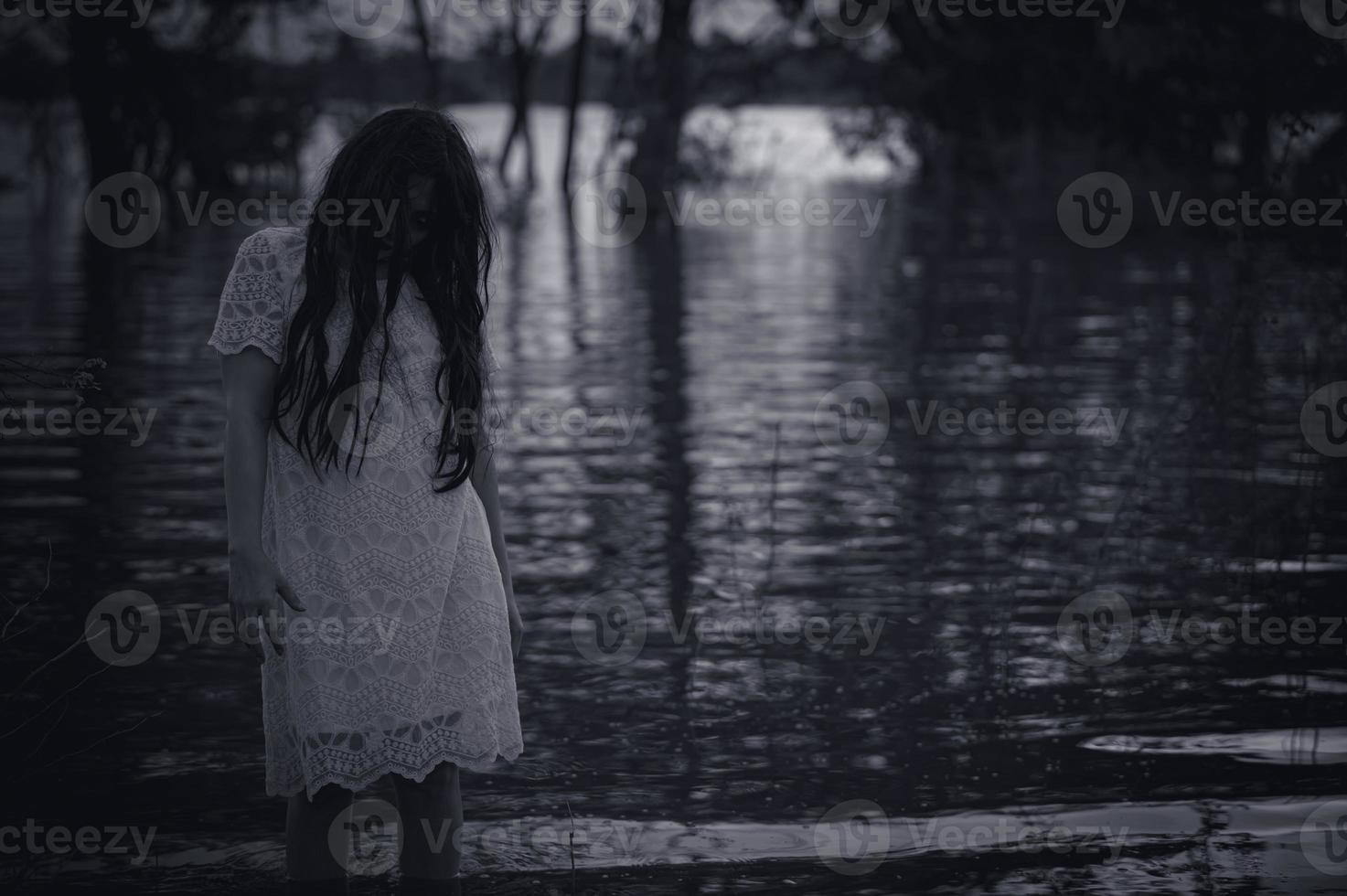 Portrait of asian woman make up ghost face at the swamp,Horror in water scene,Scary at river,Halloween poster,Thailand people photo