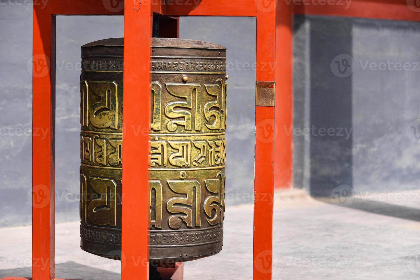 Ceremonial bell covered with tibetan inscriptions in Yonghe Temple also known as Palace of Peace and Harmony Lama Temple or simply Lama Temple in Beijing, china photo