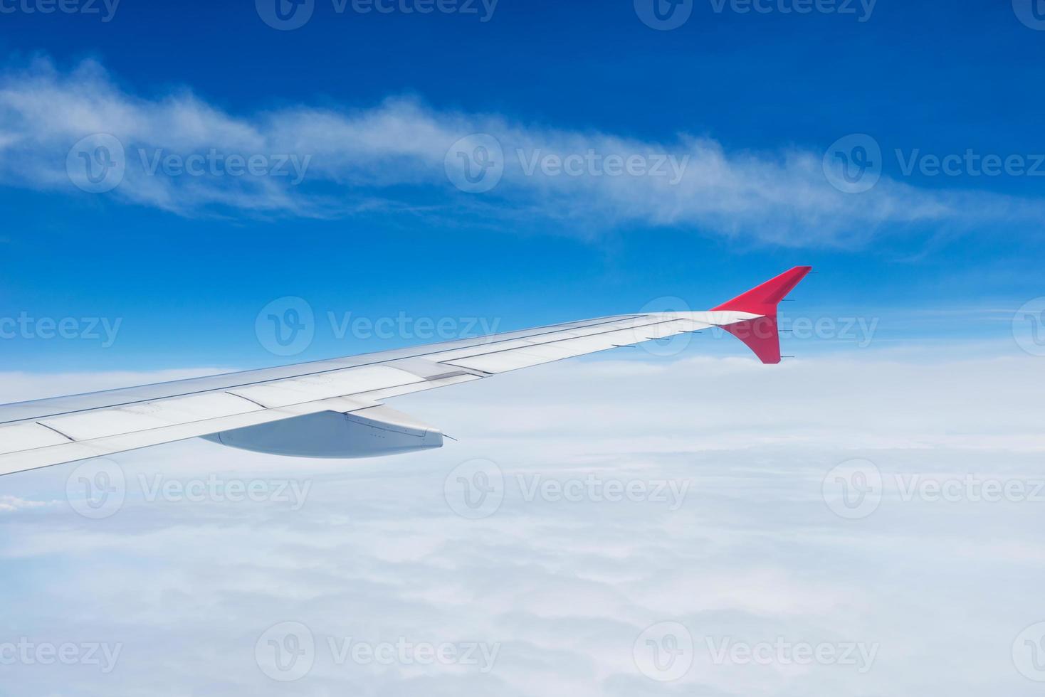 Wing of an airplane flying in the sky photo