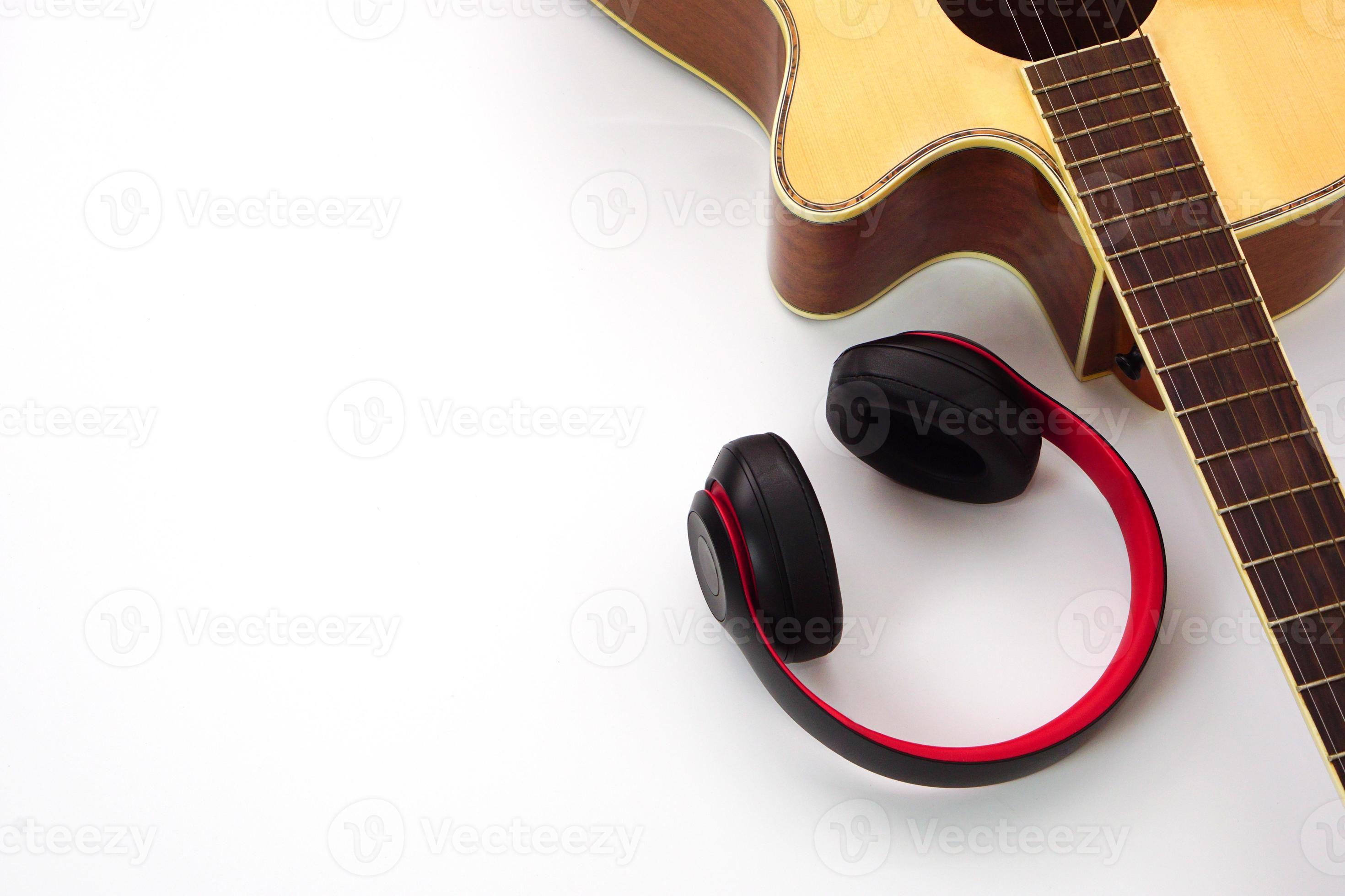 Acoustic guitar on a white background and the headphones are placed on the side. Concept of love leisure and music. 21915748 Stock Photo at Vecteezy