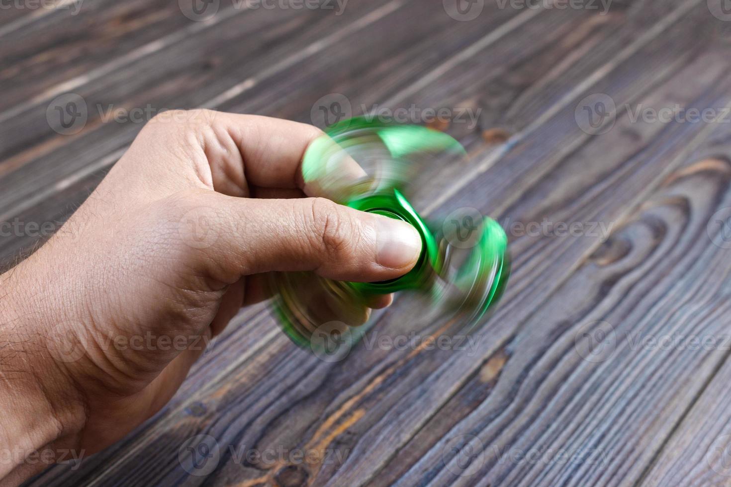 Hands holding popular fidget spinner toy. fidgeting spinner photo