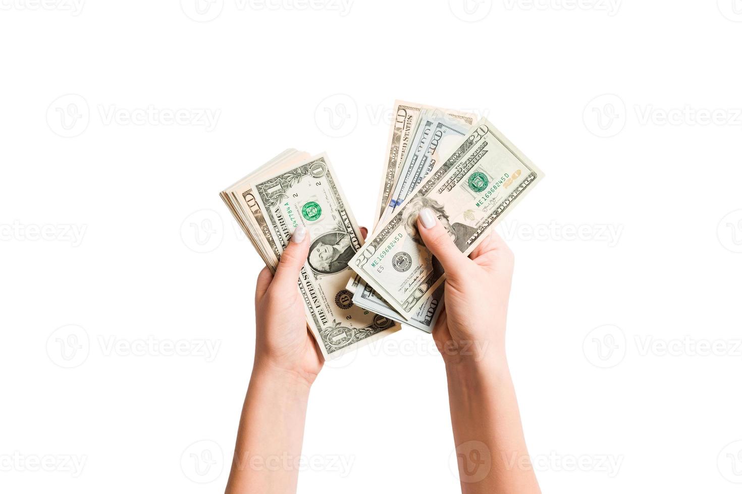 Top view of dollar banknotes in female hand on white isolated background. Business concept. Money counting photo