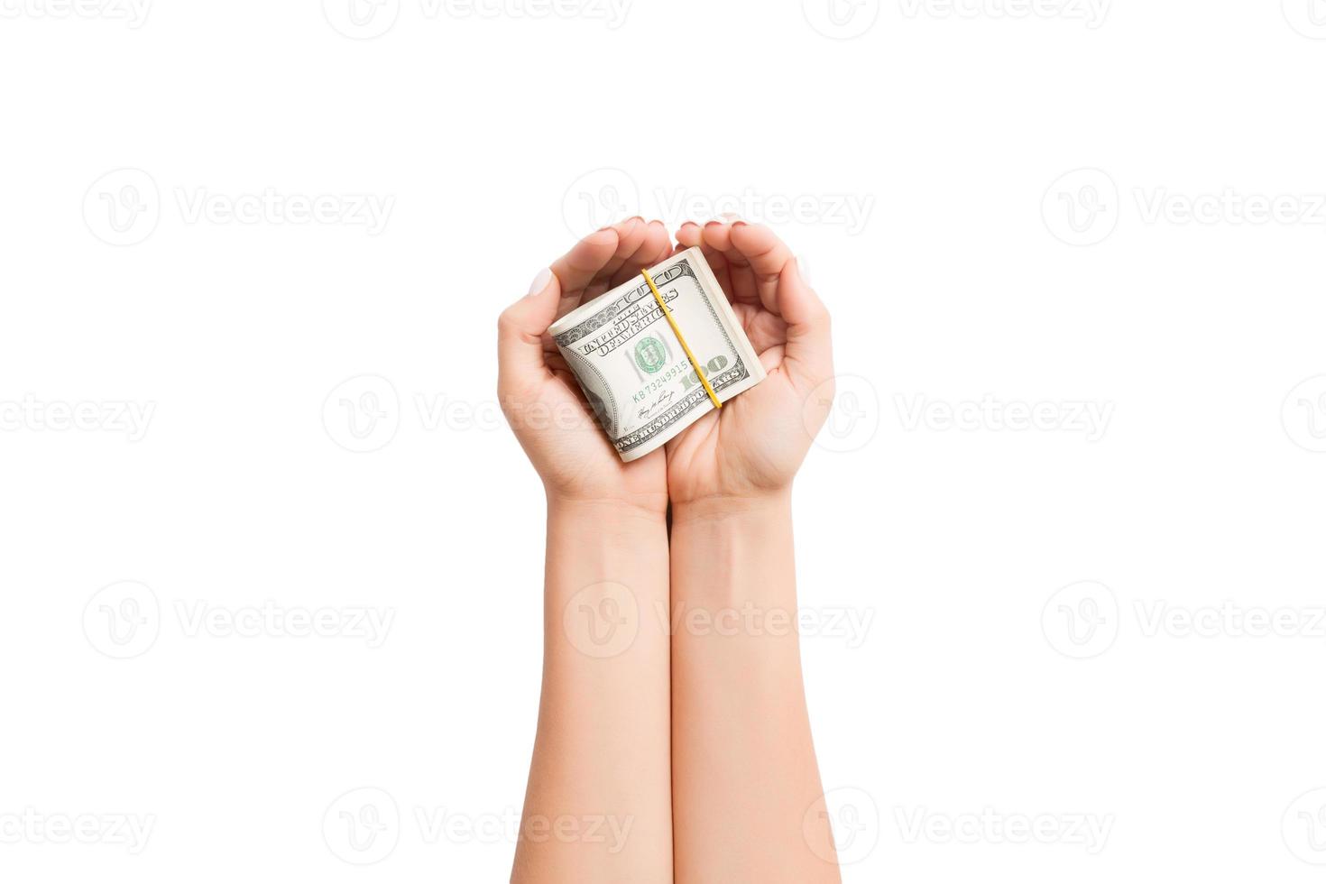 Top view of dollars in female palms on white isolated background. Small pension concept photo