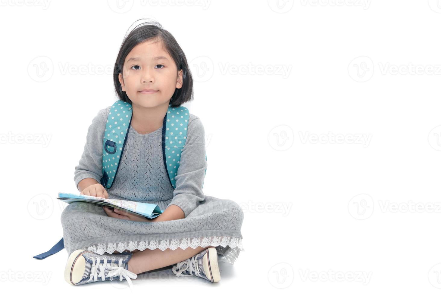 cute little traveler sitting with map isolated photo