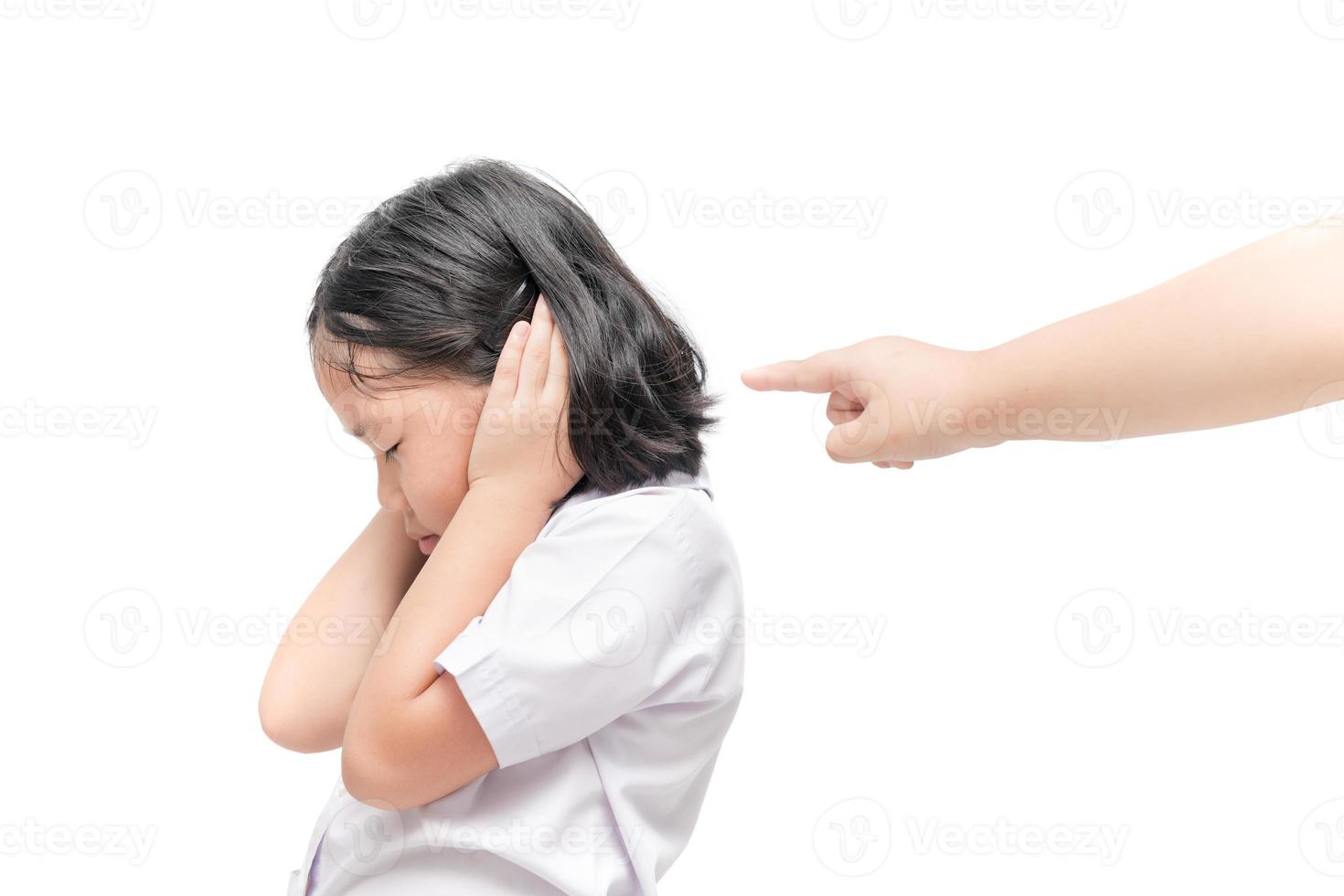 Stressed girl closing ears with hands with hand pointing photo