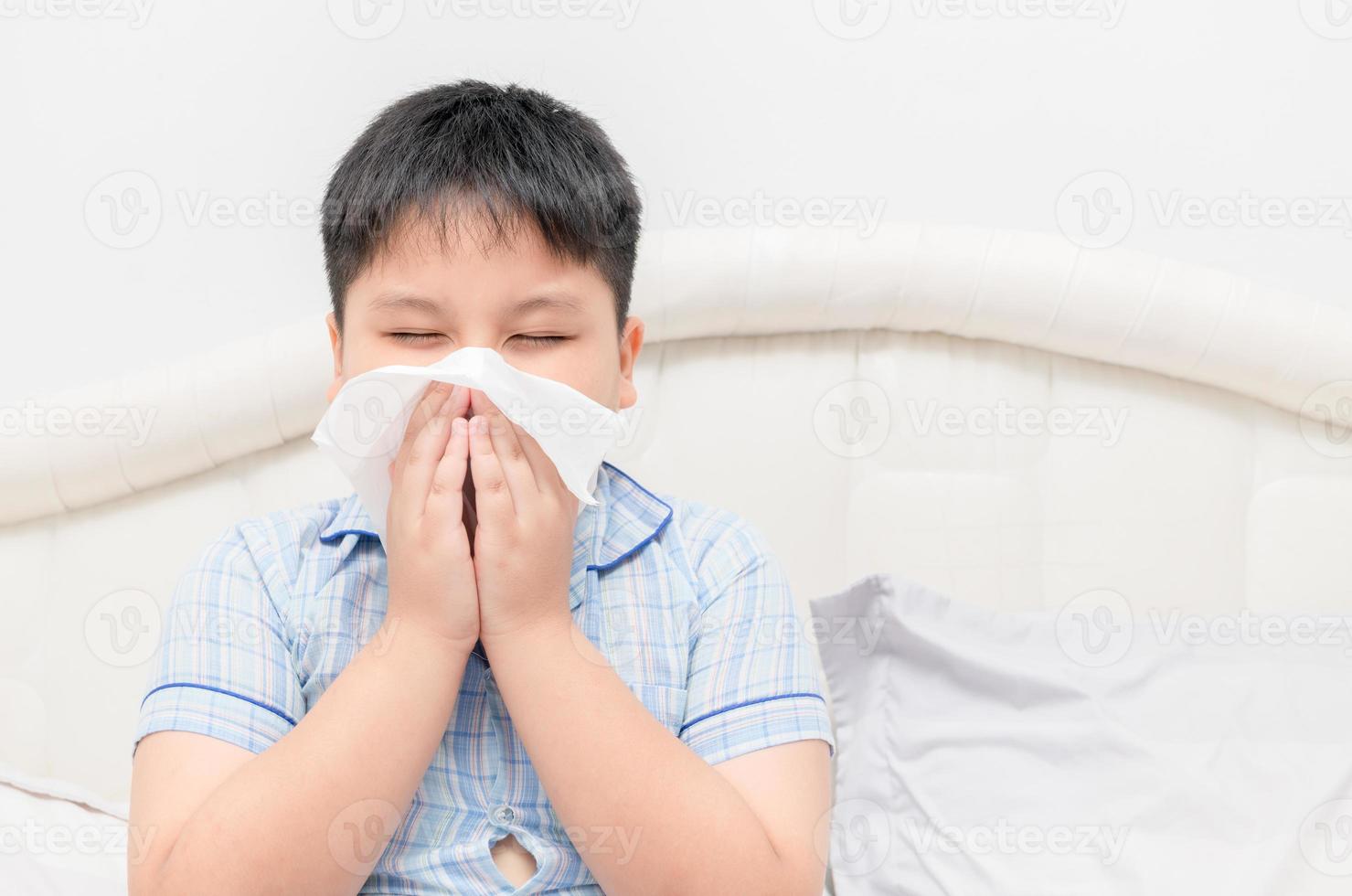obese fat boy blowing the nose by tissue photo