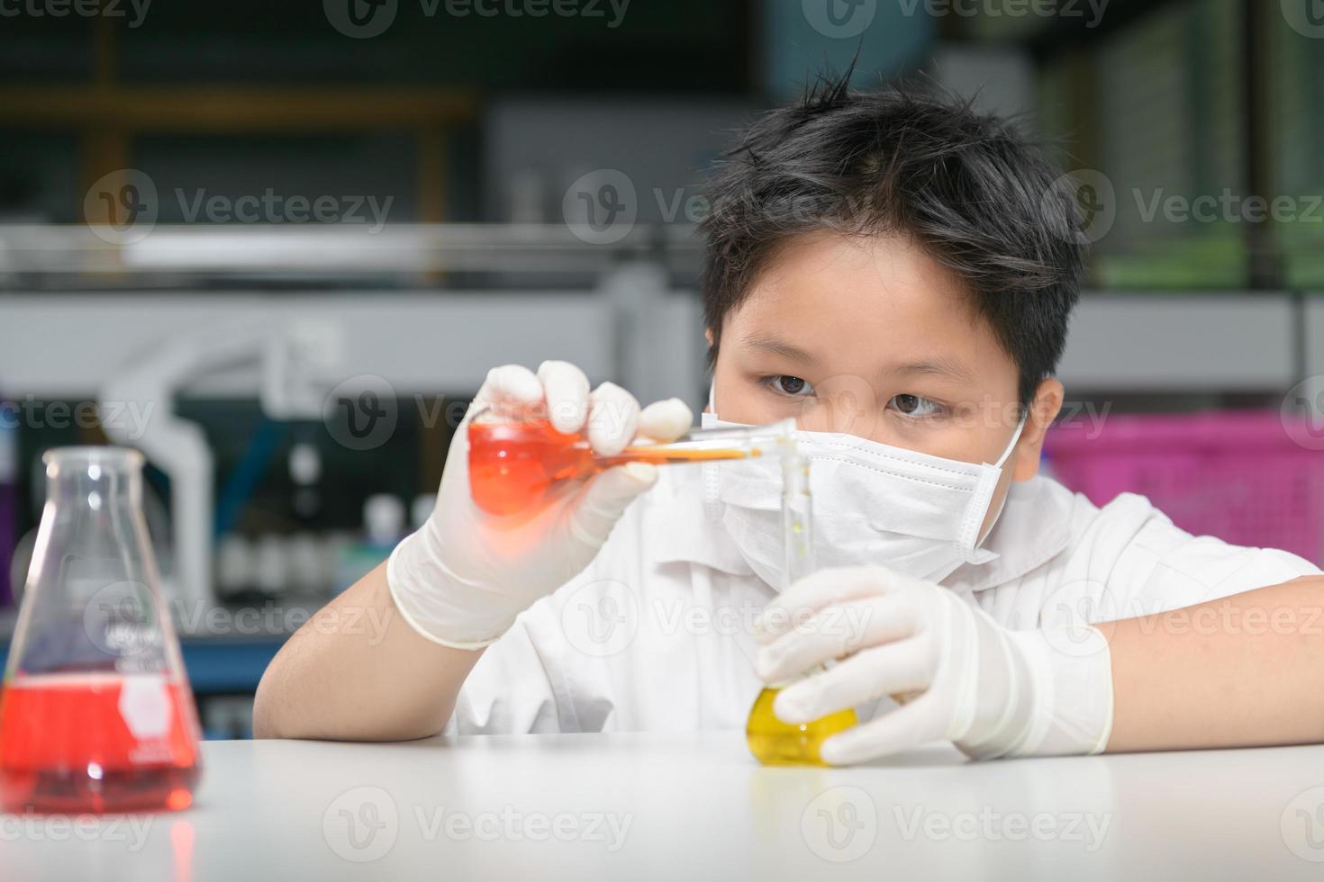 kid scientist making experiment with test tube i photo