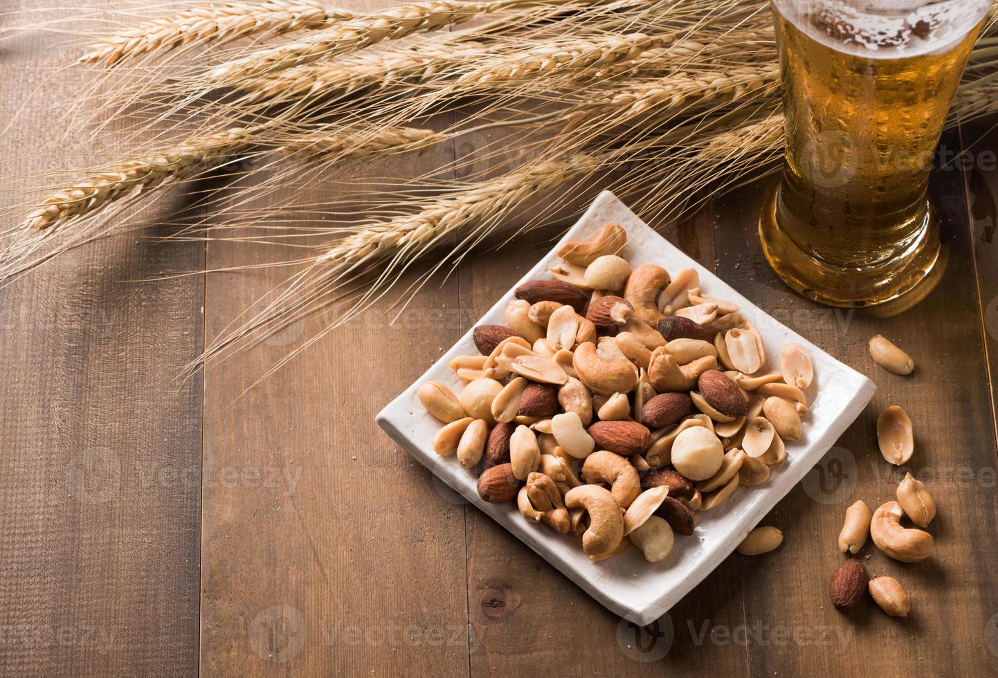 Salted mix cocktail nuts with beer and barley flower photo