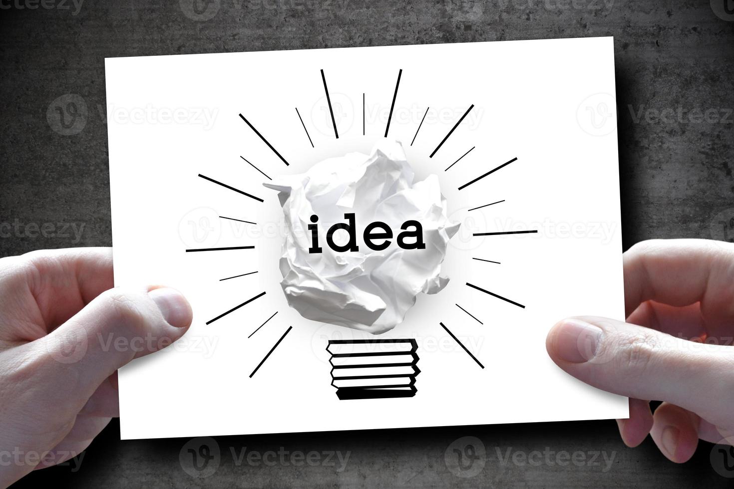 Idea, Creativity Concept - Human Hands Holding Piece of Paper with Paperball Light Bulb photo