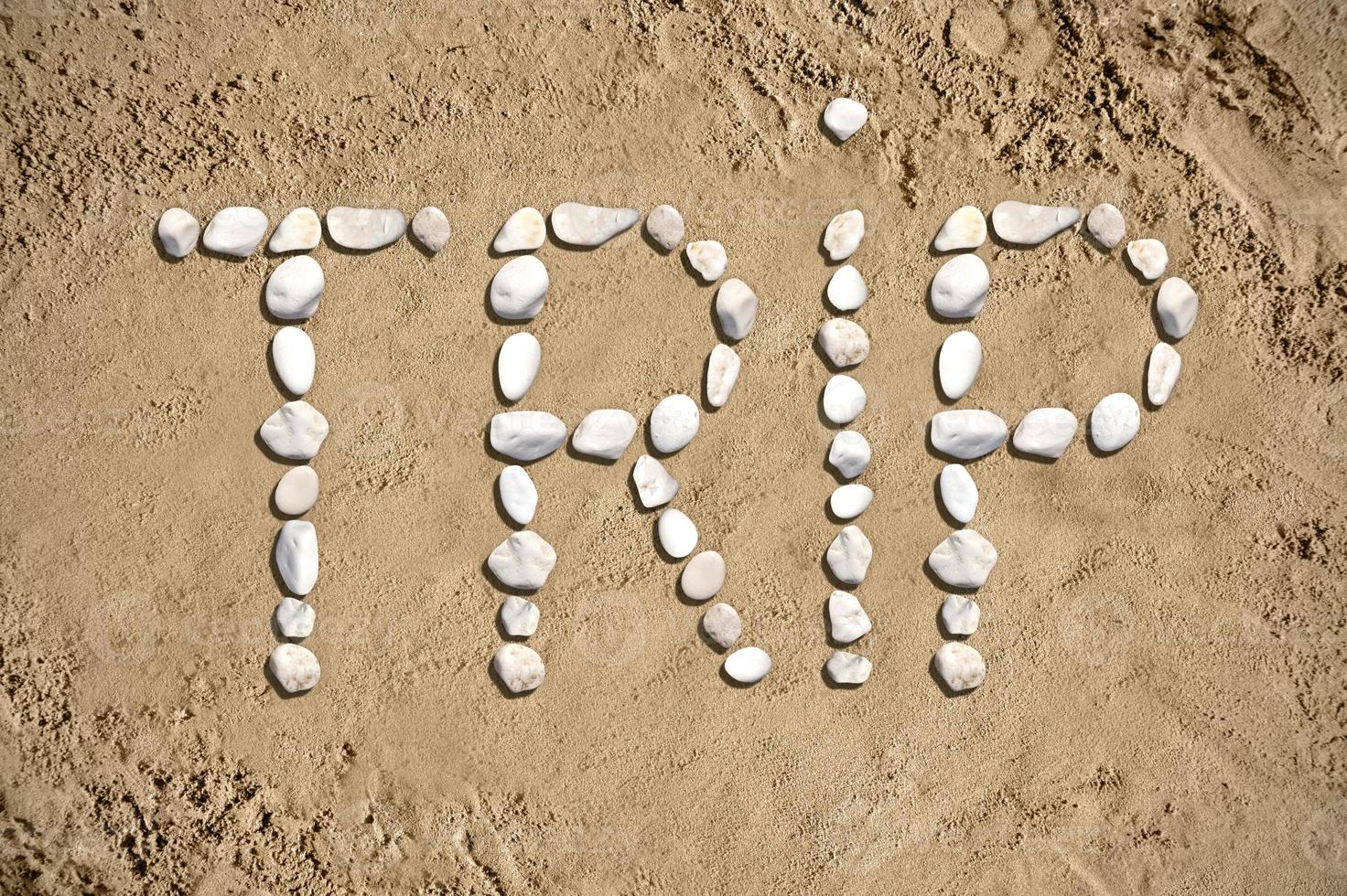 Trip - Word Made with Stones on Sand photo