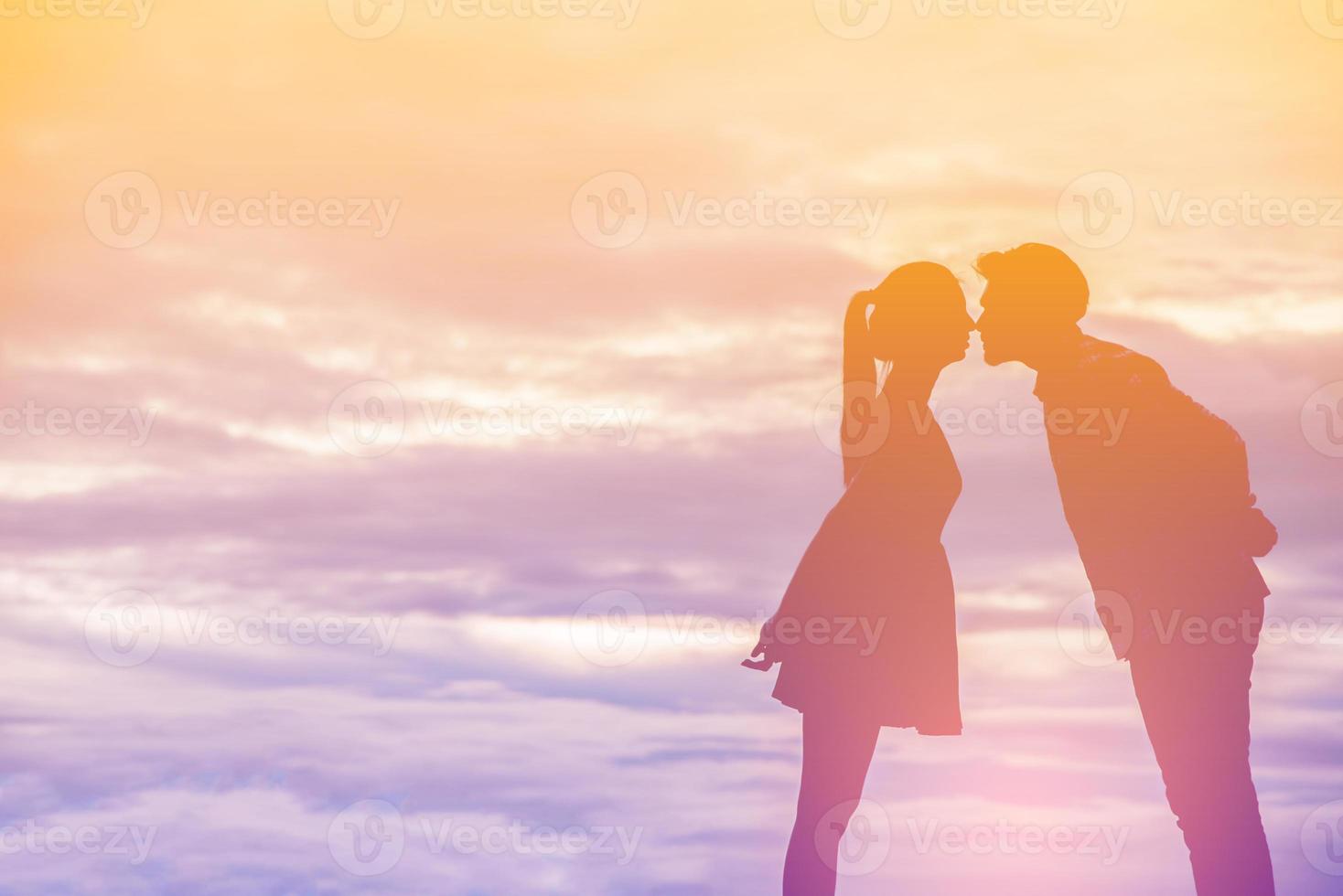 Young couple in love at sunset on the Mountain photo