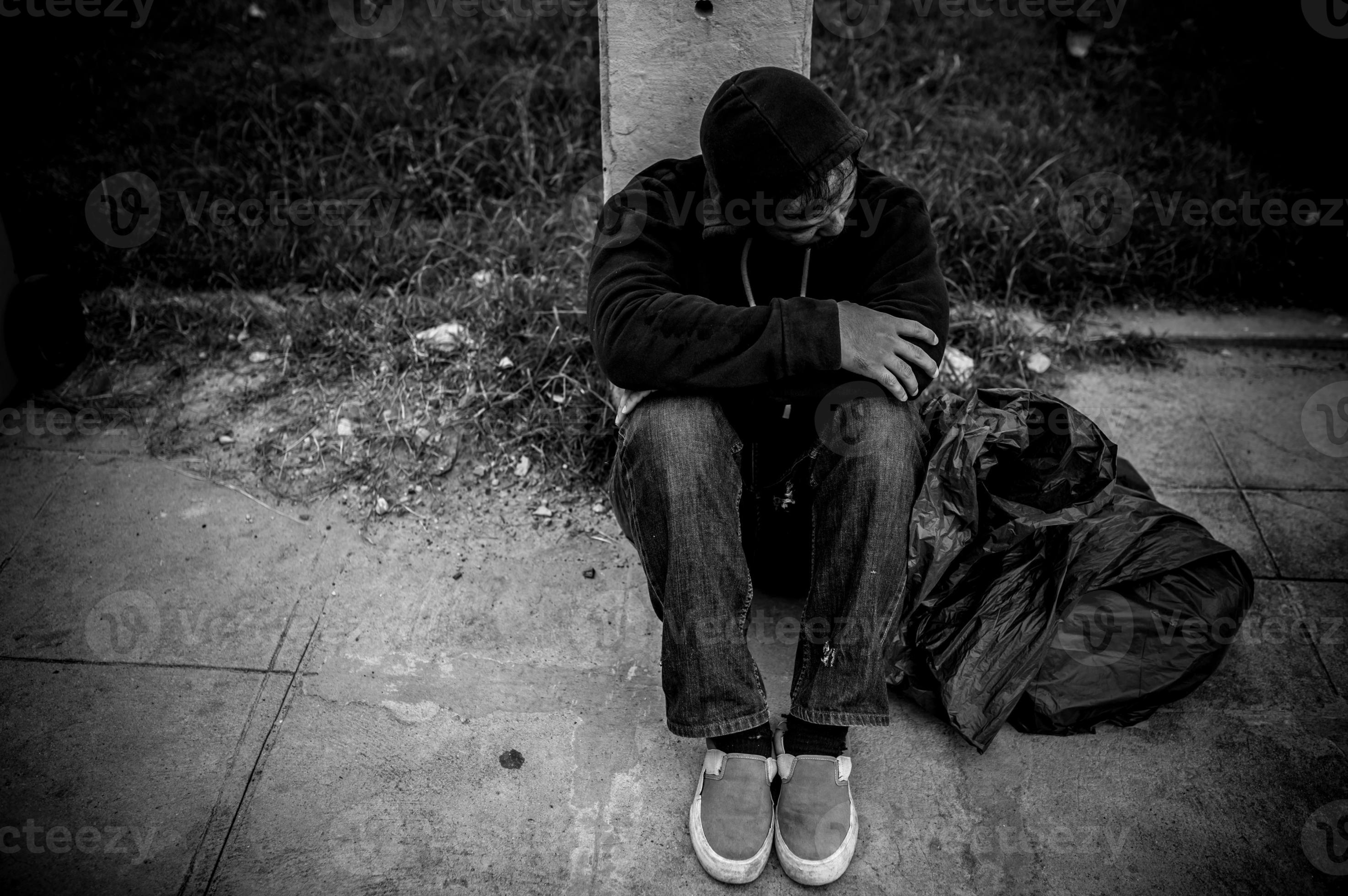 Asian man is homeless at the side road,A stranger has to live on the road alone because he has