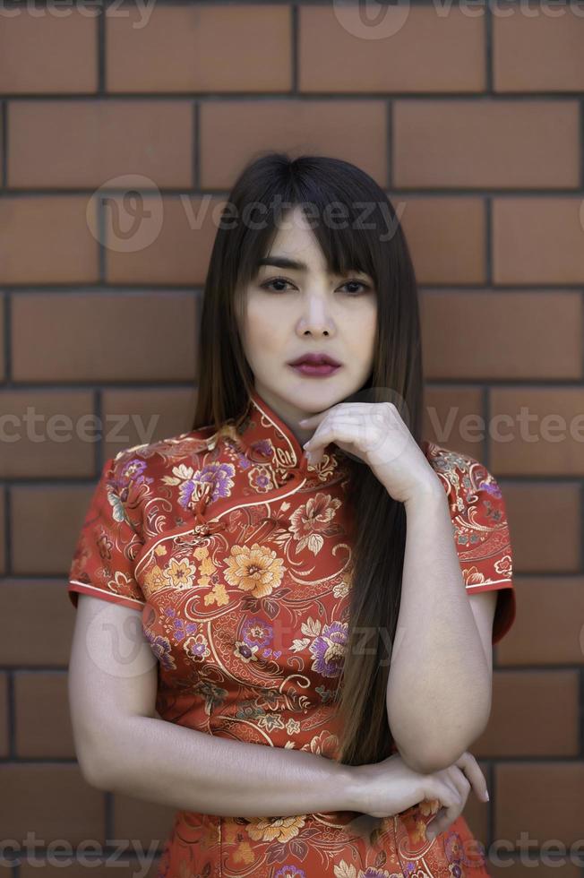 Portrait beautiful asian woman in Cheongsam dress,Thailand people,Happy Chinese new year concept,Happy asian lady in chinese traditional dress photo