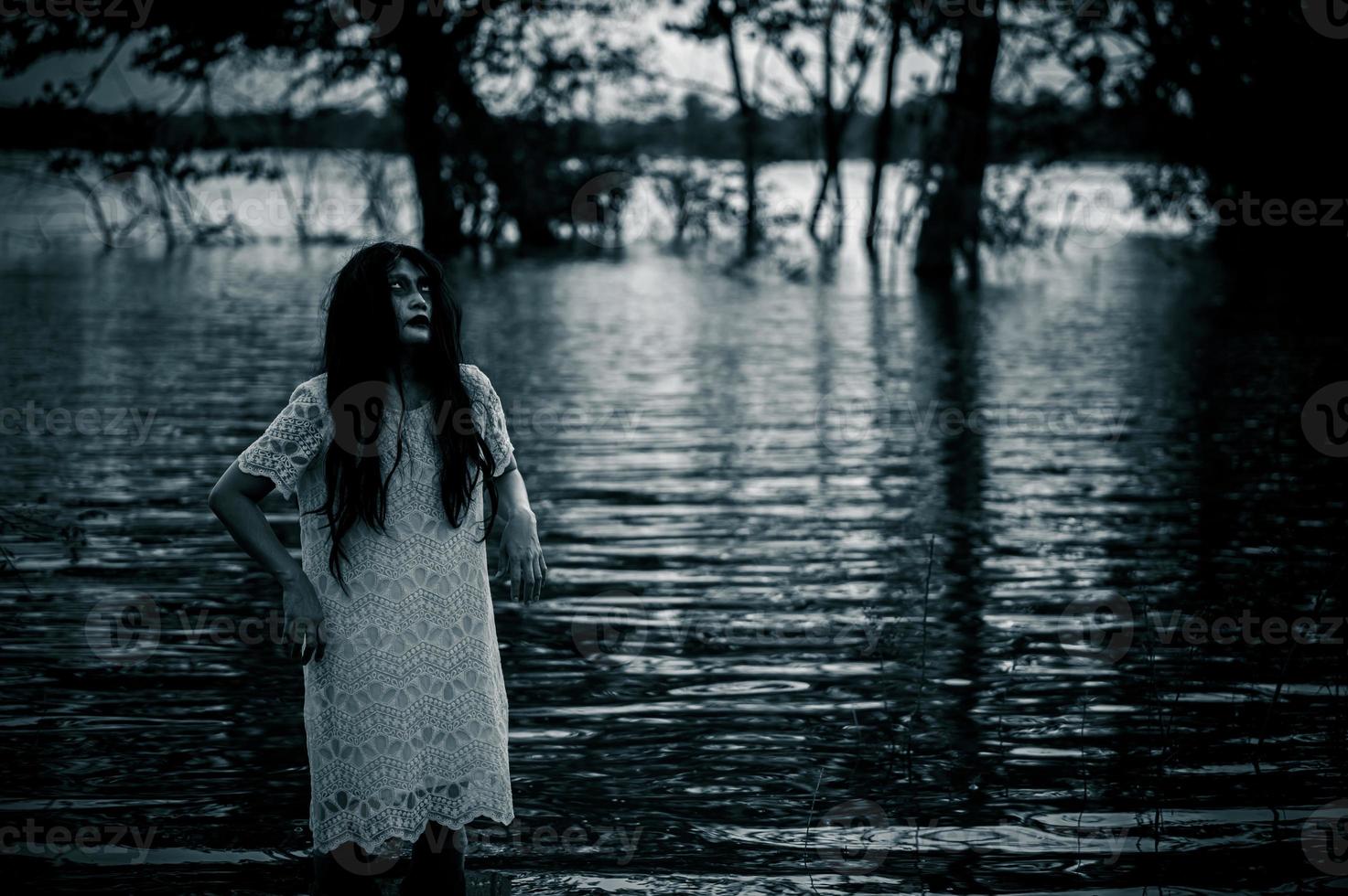 Portrait of asian woman make up ghost face at the swamp,Horror in water scene,Scary at river,Halloween poster,Thailand people photo