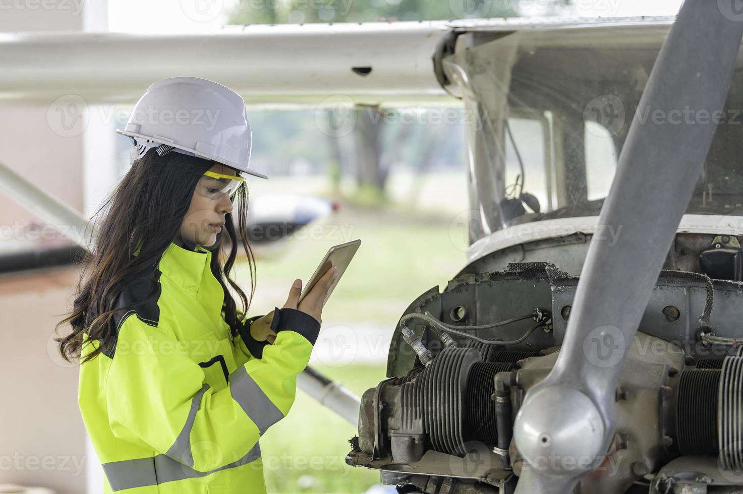 Technician fixing the engine of the airplane,Female aerospace engineering checking aircraft engines,Asian mechanic maintenance inspects plane engine photo