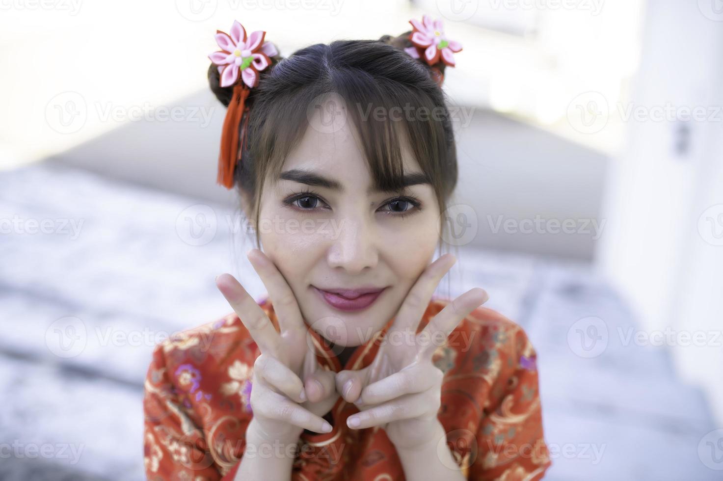 Portrait beautiful asian woman in Cheongsam dress,Thailand people,Happy Chinese new year concept,Happy asian lady in chinese traditional dress photo