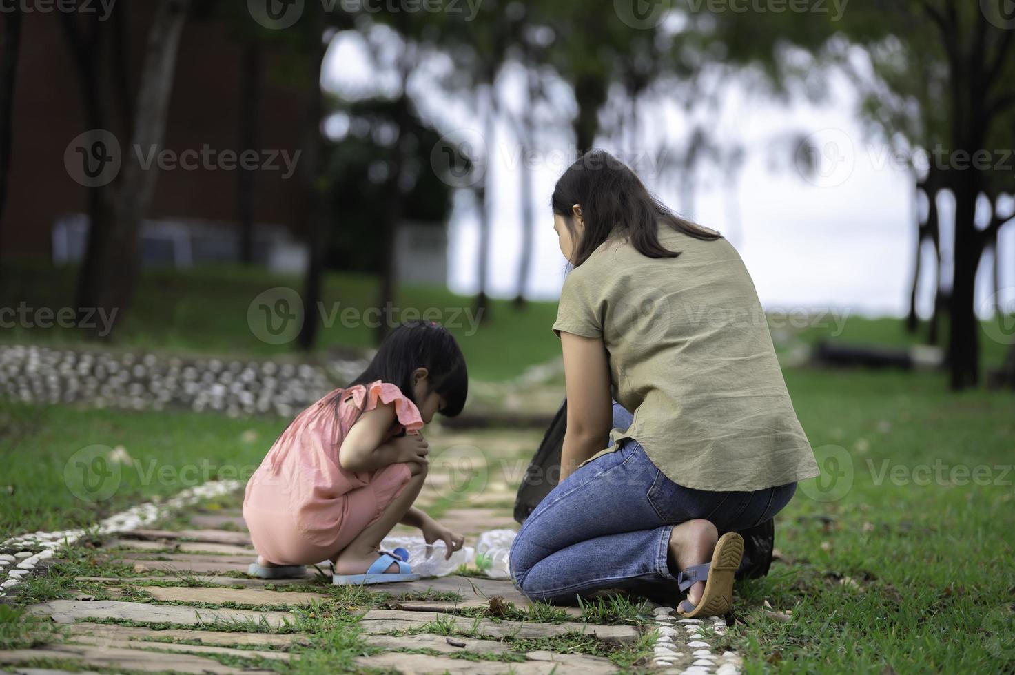 Asian mother and daughter help garbage collection charity environment. photo