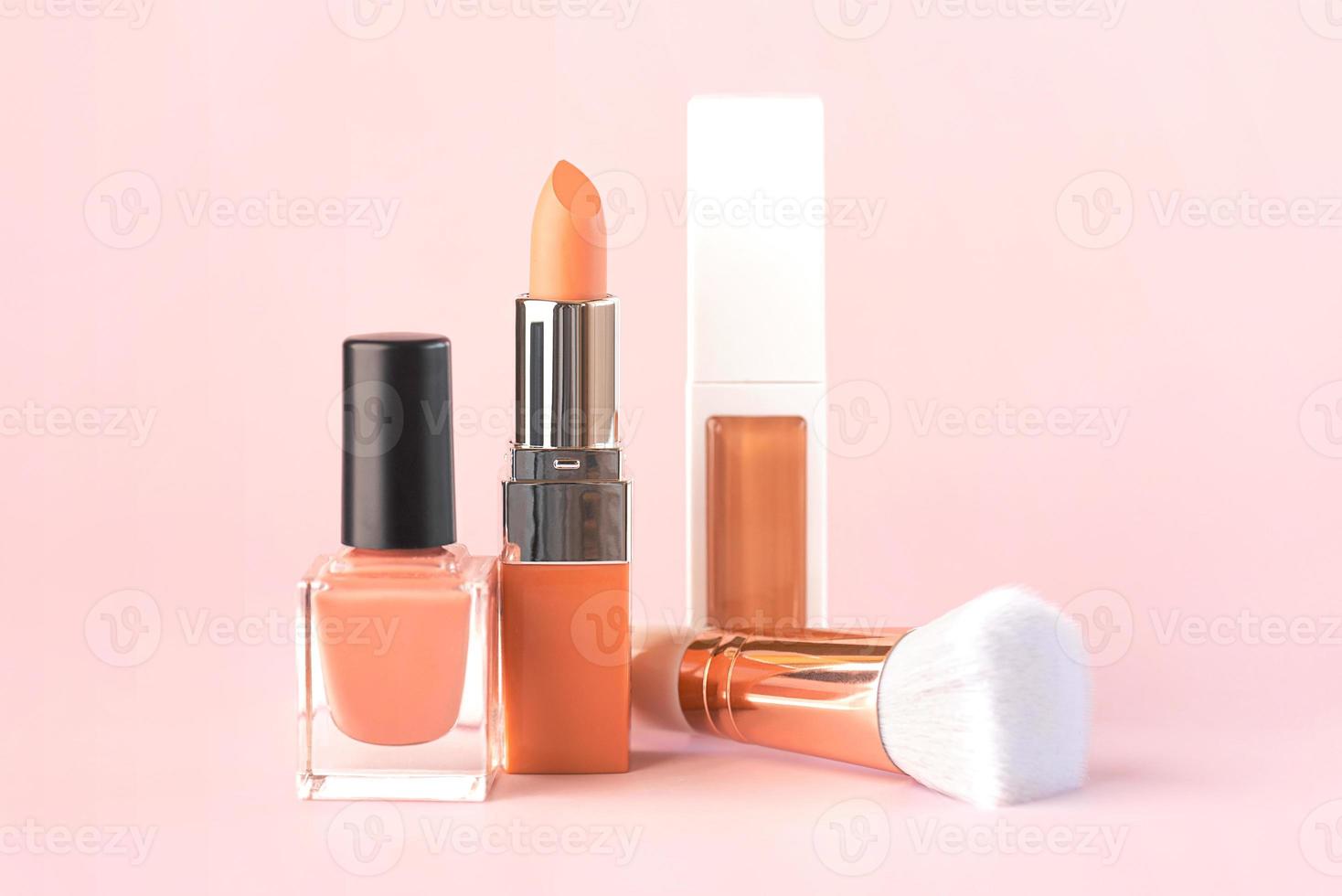 Makeup buffer brush with nail polish,lipstick and foundation. Beauty and makeup concept photo