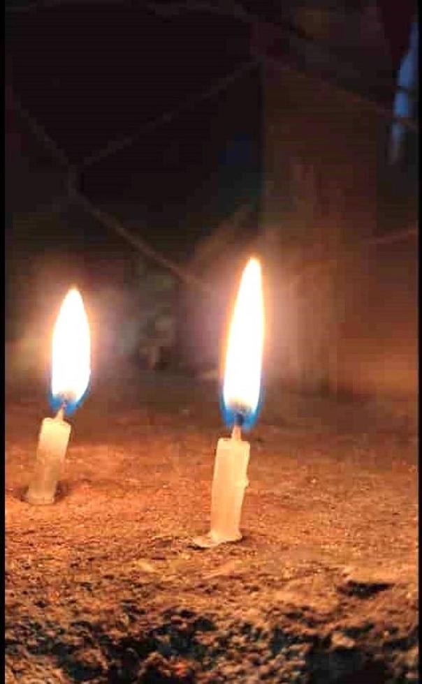 two candle lights are burning at night photo